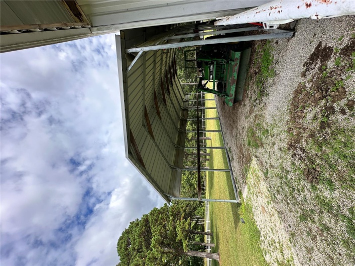View of parking featuring driveway and a carport