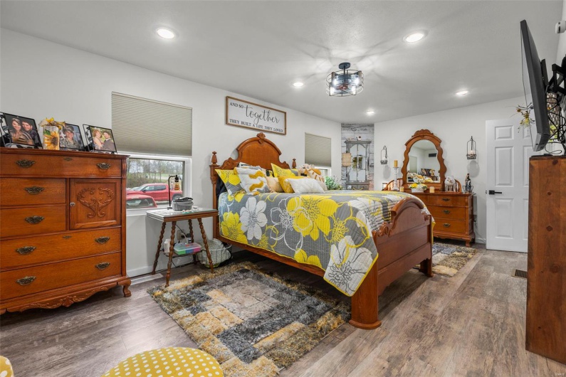 Bedroom with wood finished floors and recessed lighting