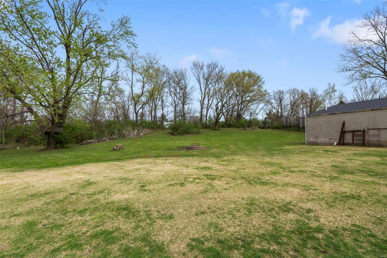 View of yard featuring an outdoor fire pit
