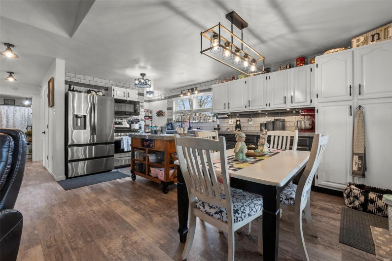 Dining area with dark wood-style floors