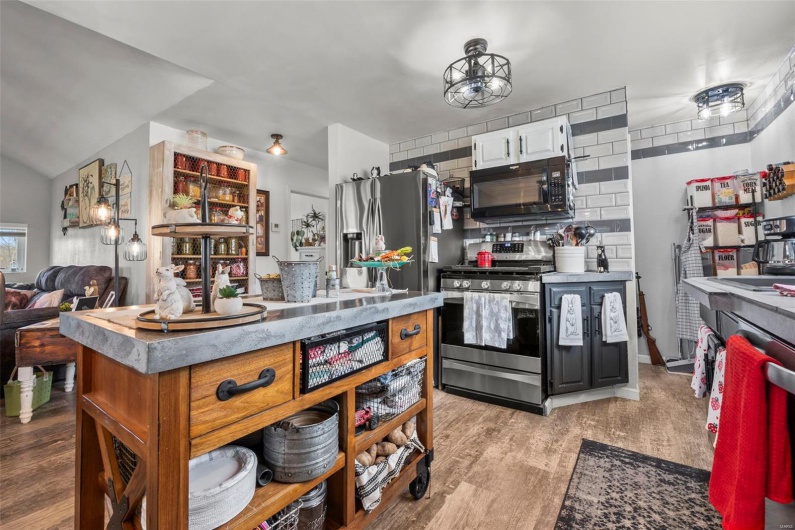 Kitchen featuring tasteful backsplash, appliances with stainless steel finishes, and light wood-type flooring