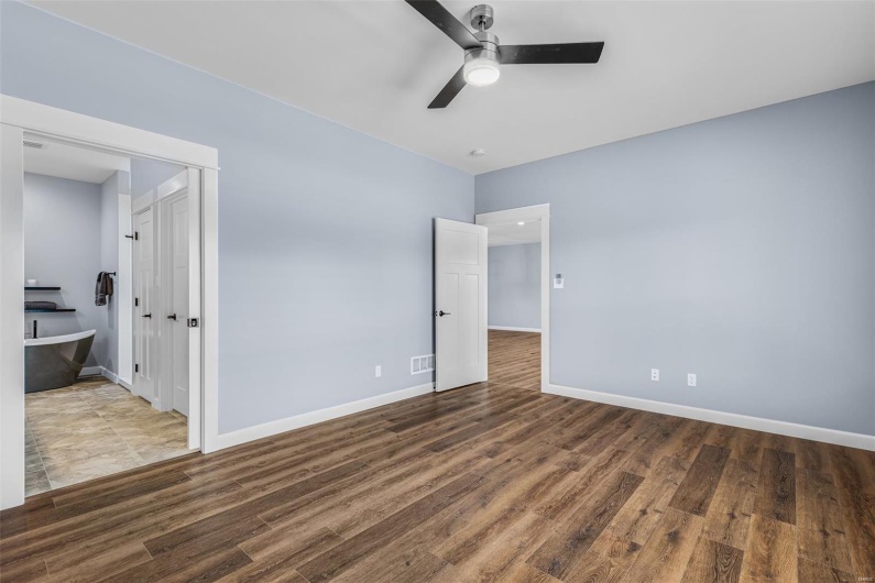 Unfurnished bedroom featuring baseboards, visible vents, and wood finished floors