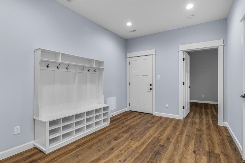 Mudroom featuring visible vents, baseboards, and wood finished floors