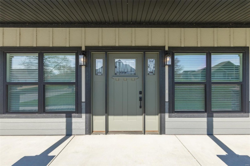 View of exterior entry featuring board and batten siding