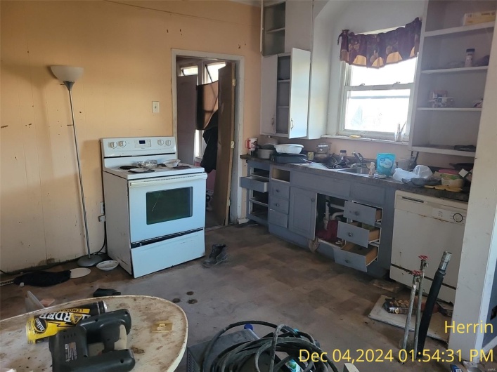 Kitchen featuring white appliances, a sink, and open shelves