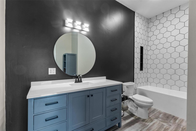 Full bathroom featuring vanity, toilet, and tiled shower / bath combo