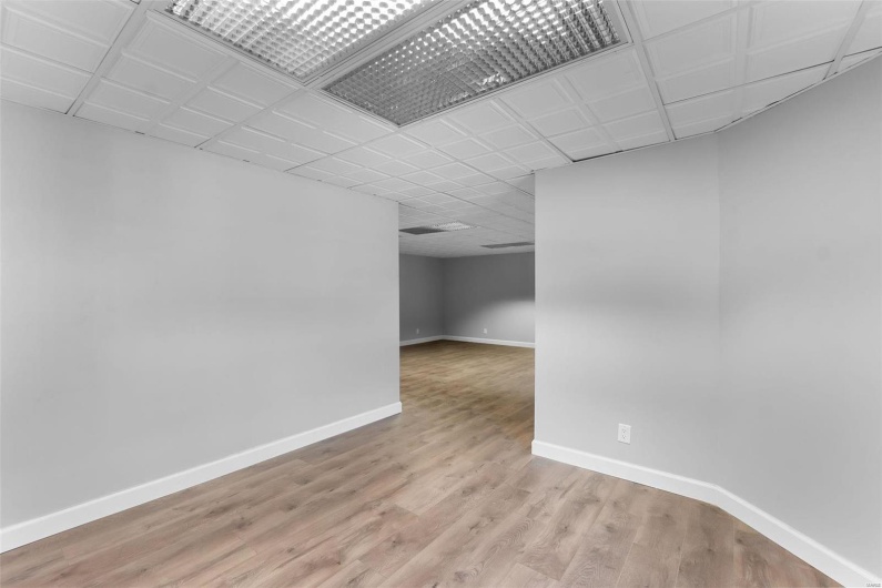 Empty room with light hardwood / wood-style floors