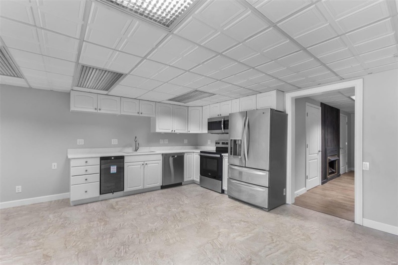 Kitchen with white cabinets, stainless steel appliances, and sink
