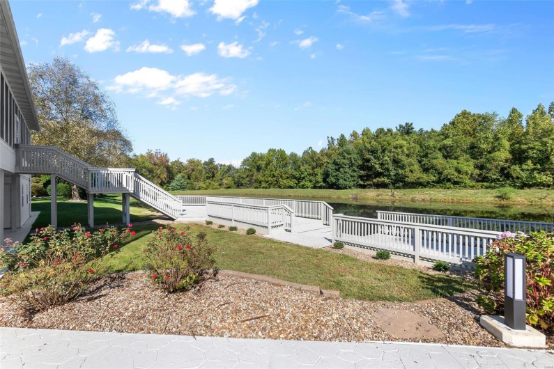 View of yard with a deck with water view