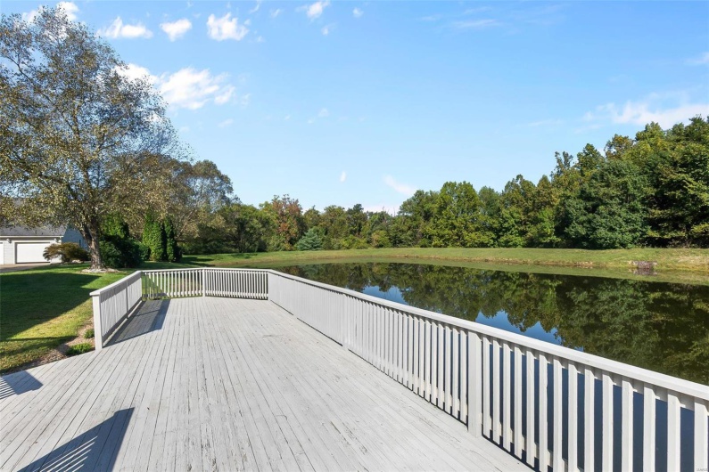 Dock area featuring a deck with water view