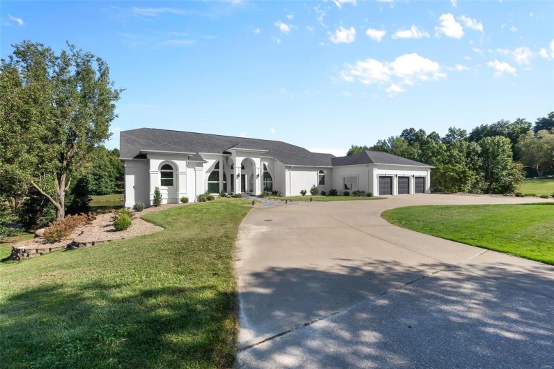 View of front of house with a front yard and a garage