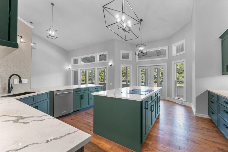 Kitchen featuring a center island, wood-type flooring, sink, decorative light fixtures, and black electric stovetop