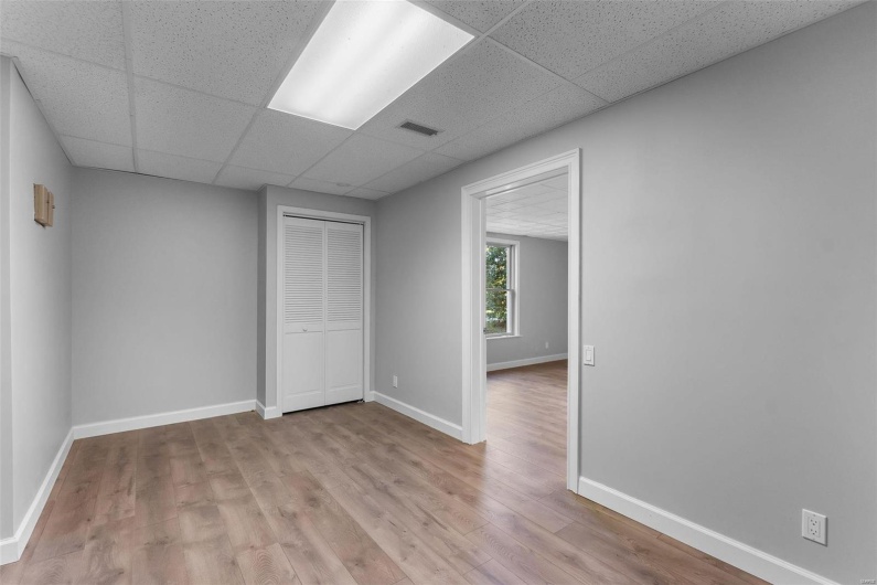 Empty room featuring a paneled ceiling and light hardwood / wood-style floors