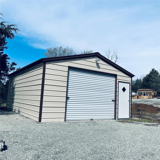 Detached garage with gravel driveway
