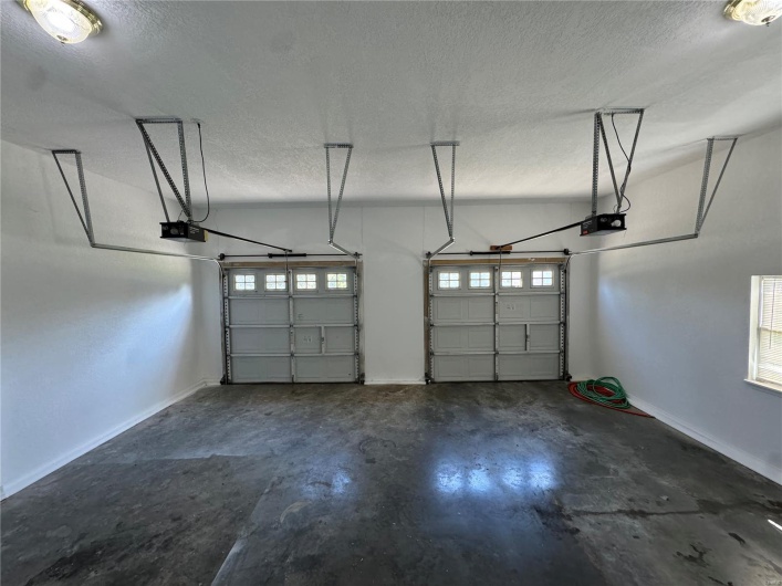 Garage with a garage door opener and baseboards