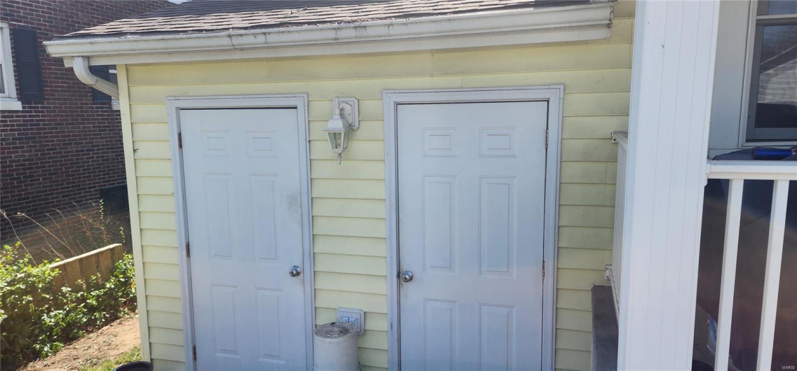 Property entrance featuring a shingled roof