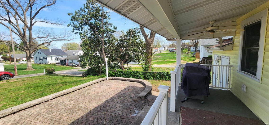View of patio / terrace featuring a residential view, grilling area, and ceiling fan