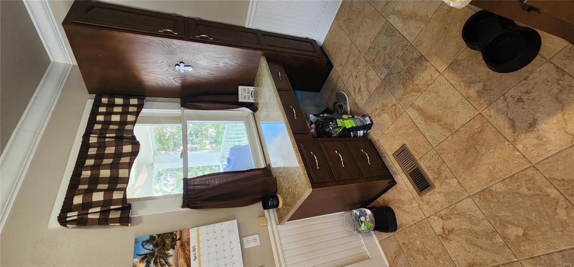Bathroom with ornamental molding, visible vents, and wainscoting