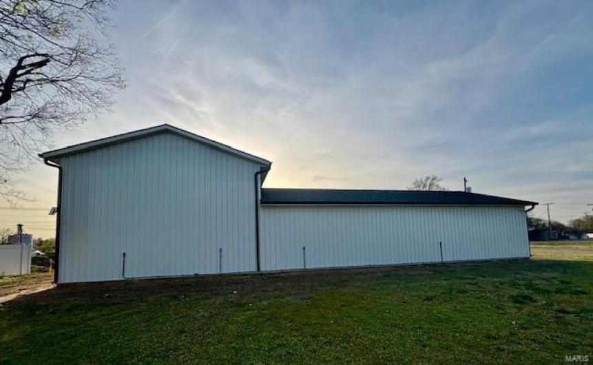 View of pole building featuring a lawn