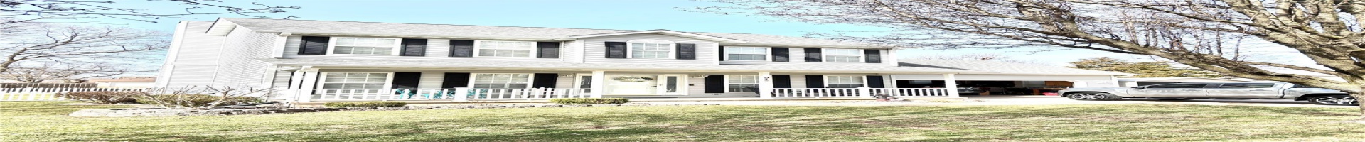 Residential For Sale Colonial-style house with covered porch, a garage, fence, concrete driveway, and a front lawn