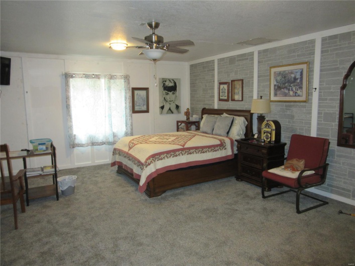 Carpeted bedroom with a textured ceiling