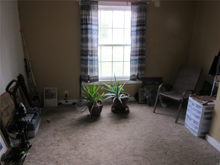 Living area featuring plenty of natural light and carpet