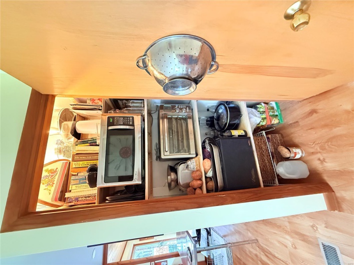 Details featuring a toaster, visible vents, and wood finished floors