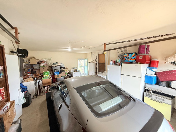 Garage with separate washer and dryer and freestanding refrigerator