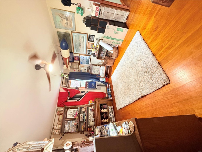 Living area with ceiling fan and wood finished floors