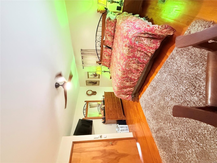 Bedroom with ceiling fan and wood finished floors