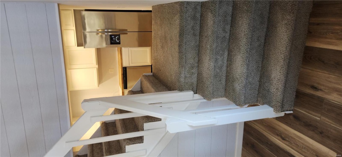 Staircase to upper level / eat in kitchen area