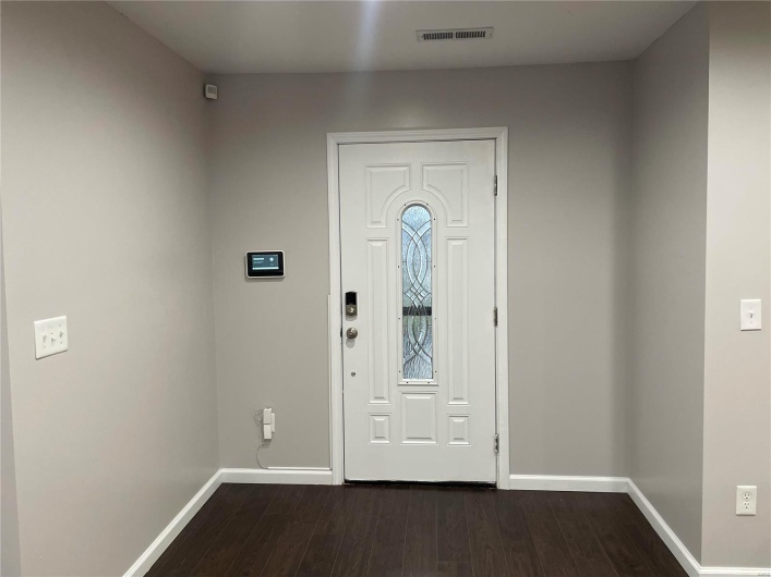 Entrance foyer with dark wood-type flooring