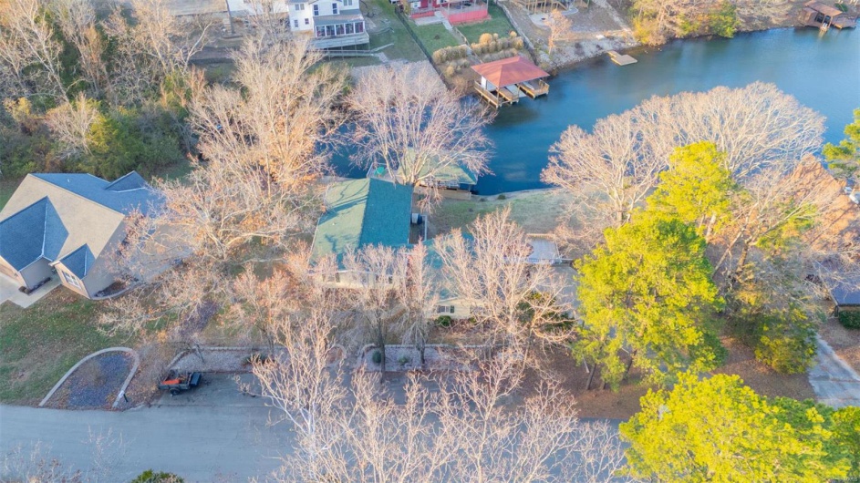 Birds eye view of property with a water view