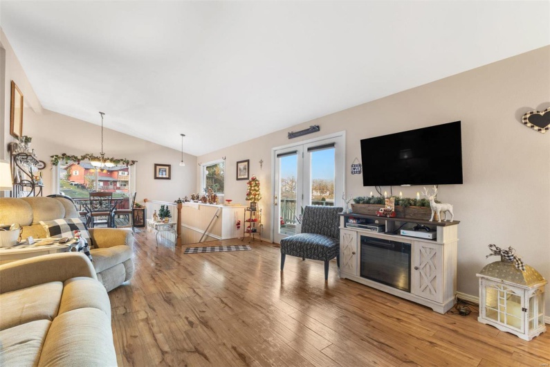 Living room featuring wood-type flooring and lofted ceiling