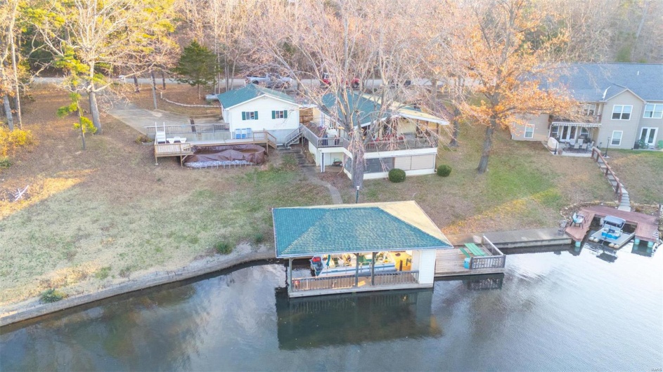Birds eye view of property with a water view