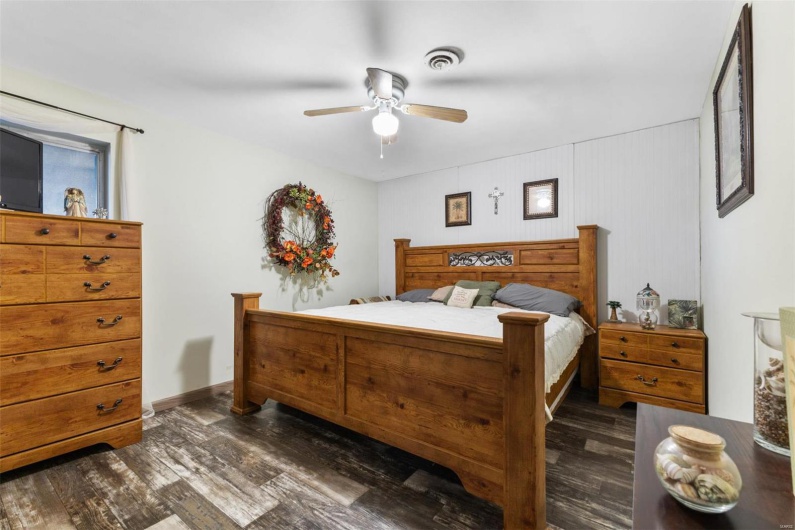 Bedroom featuring ceiling fan and dark wood-type flooring