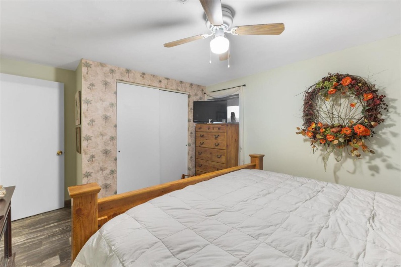 Bedroom featuring ceiling fan and hardwood / wood-style flooring