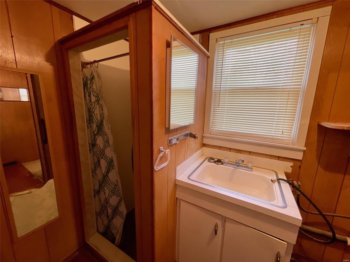 Full bathroom with vanity and curtained shower