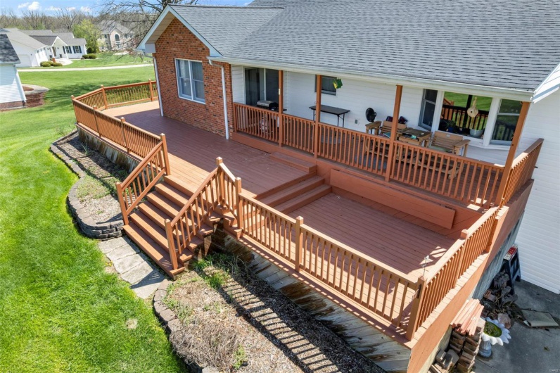 Wooden terrace featuring a residential view and a lawn
