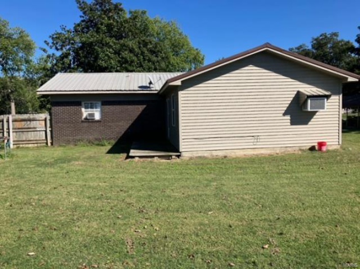 View of property exterior featuring a yard