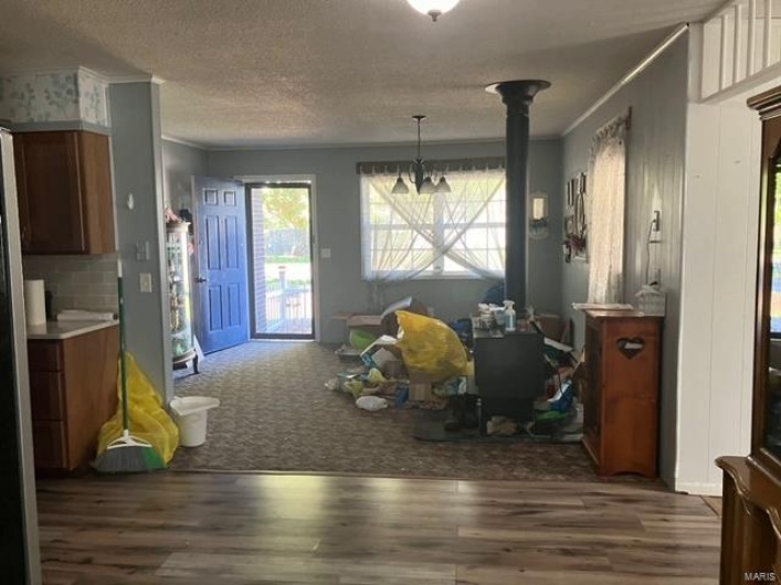Dining room featuring ornamental molding, a textured ceiling, and dark hardwood / wood-style flooring