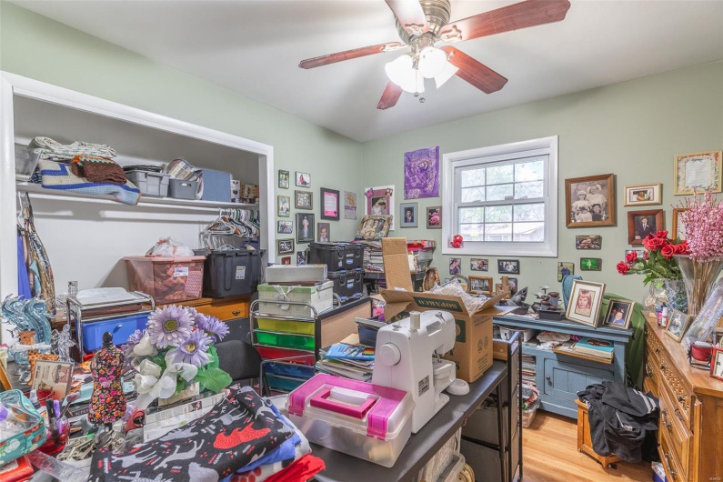Office with wood finished floors and a ceiling fan