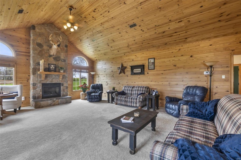 New addition in 2002, stone fireplace, wood walls, wood ceiling, and high vaulted ceiling.