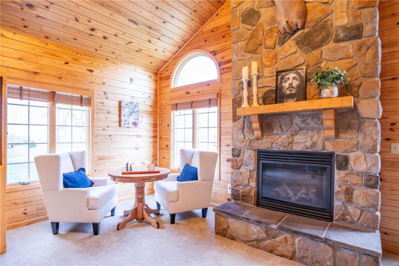 New addition in 2002, stone fireplace, wood walls, wood ceiling, and high vaulted ceiling.