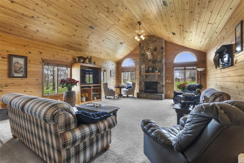 New addition in 2002, stone fireplace, wood walls, wood ceiling, and high vaulted ceiling.