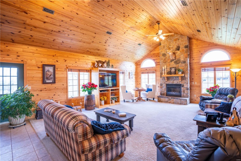 New addition in 2002, stone fireplace, wood walls, wood ceiling, and high vaulted ceiling.