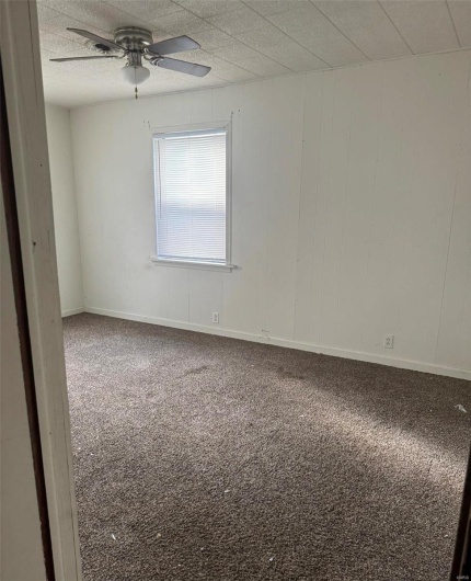 Spare room featuring ceiling fan and carpet floors