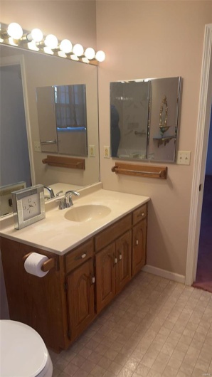 Bathroom featuring vanity and baseboards