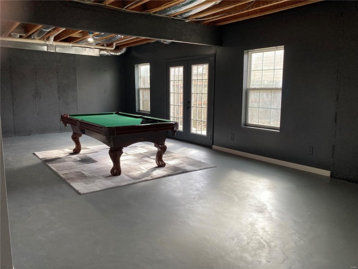 Recreation room with pool table, concrete floors, and french doors