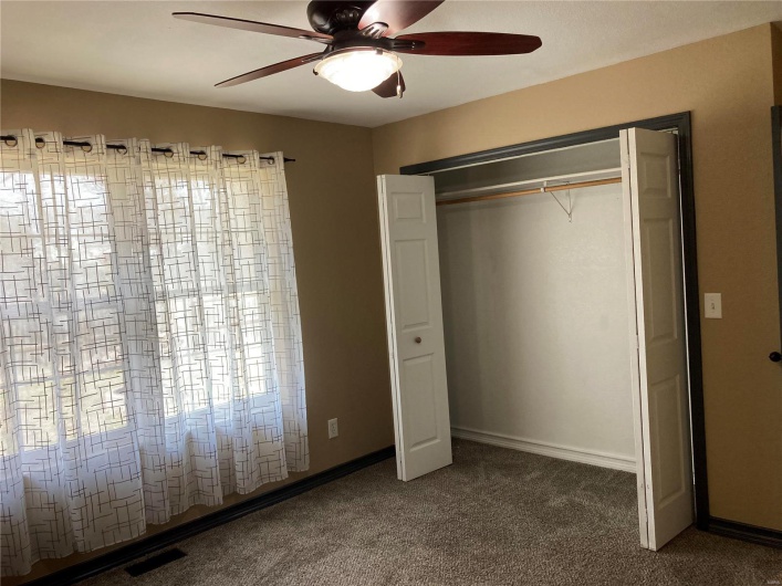 Unfurnished bedroom with visible vents, a ceiling fan, a closet, carpet, and baseboards